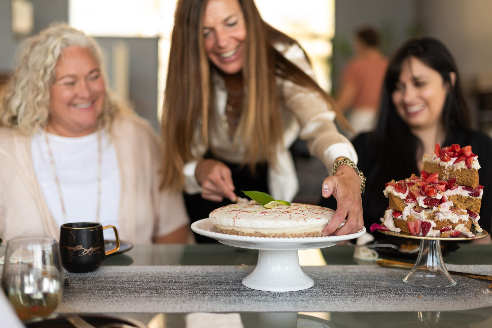 Caitlin serving a cake from the cookbook
