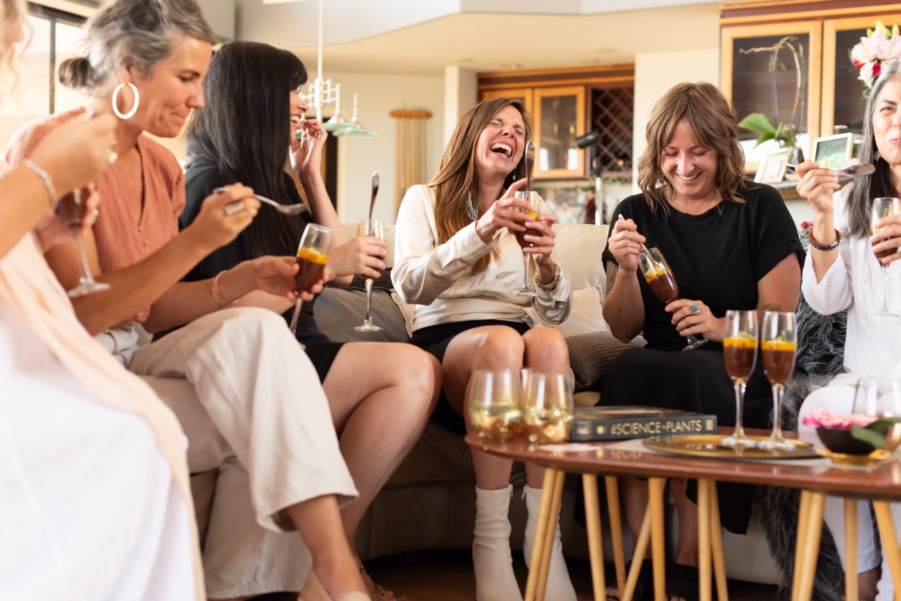 Women gathered with champagne at a Cake Salon